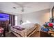 Bedroom with wood floors, ceiling fan, and natural light from the sliding glass doors, with basic furnishings at 5399 Surrey St, Las Vegas, NV 89119