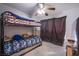 Bedroom showing a bunk bed, curtains and ceiling fan, which maximizes space and comfort at 5399 Surrey St, Las Vegas, NV 89119