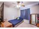 Bedroom with carpet, ceiling fan, and a window providing natural light at 5399 Surrey St, Las Vegas, NV 89119