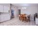 Kitchen area with tile flooring, white cabinets, dining table, and a view into another room at 5399 Surrey St, Las Vegas, NV 89119