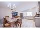 Kitchen area with tile flooring, white cabinets, stainless steel appliances, and a dining table at 5399 Surrey St, Las Vegas, NV 89119