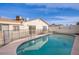 Backyard pool area with a safety fence and view of the home's exterior at 5399 Surrey St, Las Vegas, NV 89119