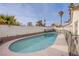 Backyard pool features steps and a safety fence with palm trees at 5399 Surrey St, Las Vegas, NV 89119