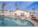 Backyard pool with safety fence and view of the home's exterior at 5399 Surrey St, Las Vegas, NV 89119