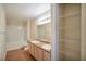 Bright bathroom with double sink vanity, bath, and organized shelving at 555 E Silverado Ranch Blvd # 2033, Las Vegas, NV 89183