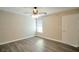 Neutral bedroom features wood-look floors, closet, and ample natural light from a window at 555 E Silverado Ranch Blvd # 2033, Las Vegas, NV 89183