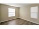 Bedroom featuring wood-look floors, base trim, and two windows with blinds at 555 E Silverado Ranch Blvd # 2033, Las Vegas, NV 89183