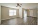 Bright living room with wood-look floors, neutral paint, ceiling fan, and sliding glass doors at 555 E Silverado Ranch Blvd # 2033, Las Vegas, NV 89183