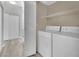 Laundry area with a washer, dryer, and shelving, offering convenience and organization at 5650 E Sahara Ave # 1029, Las Vegas, NV 89142