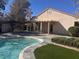 Back of house with manicured lawn and in-ground pool, perfect for entertaining or relaxing at 5748 Spring Ranch Pkwy, Las Vegas, NV 89118