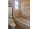 Updated bathroom with stone accent wall over bathtub at 5748 Spring Ranch Pkwy, Las Vegas, NV 89118