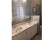 Bathroom featuring double sinks, ample lighting, and wood accents at 5748 Spring Ranch Pkwy, Las Vegas, NV 89118