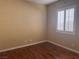 Cozy bedroom with hardwood floors and a window offering natural light at 5748 Spring Ranch Pkwy, Las Vegas, NV 89118