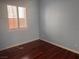 Bright bedroom with hardwood floors, window with plantation shutters, and neutral walls at 5748 Spring Ranch Pkwy, Las Vegas, NV 89118