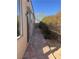 House exterior with a stone walkway along the side of the house, connecting the front and back yards at 5748 Spring Ranch Pkwy, Las Vegas, NV 89118