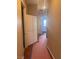 Hallway with wood floors and storage closet, leading to sunlit bedroom at 5748 Spring Ranch Pkwy, Las Vegas, NV 89118