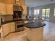 Bright, open concept kitchen featuring Viking appliances, white cabinetry, and granite countertops at 5748 Spring Ranch Pkwy, Las Vegas, NV 89118