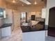 Open kitchen with a skylight, white cabinets, black countertops, and an island perfect for cooking at 5748 Spring Ranch Pkwy, Las Vegas, NV 89118