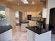 Spacious kitchen featuring white cabinetry, black granite countertops, and stainless steel appliances at 5748 Spring Ranch Pkwy, Las Vegas, NV 89118