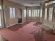 Bright living room with wood flooring, fireplace, fresh paint, and double doors leading to outdoor area at 5748 Spring Ranch Pkwy, Las Vegas, NV 89118