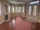 Inviting living room with wood floors, fireplace, fresh paint, and double doors leading to outdoor area at 5748 Spring Ranch Pkwy, Las Vegas, NV 89118