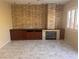 Cozy living room with modern tile flooring, a stone fireplace, and custom built-in cabinetry at 5748 Spring Ranch Pkwy, Las Vegas, NV 89118