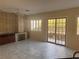 Inviting living room with fireplace, tiled floors, and a sliding glass door with backyard access at 5748 Spring Ranch Pkwy, Las Vegas, NV 89118