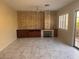 Cozy living room with modern tile flooring, a stone fireplace, and custom built-in cabinetry at 5748 Spring Ranch Pkwy, Las Vegas, NV 89118