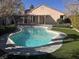 Backyard oasis featuring a sparkling pool, manicured landscaping, and a charming patio area at 5748 Spring Ranch Pkwy, Las Vegas, NV 89118