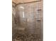 Walk-in shower with stone flooring, wall niches, and glass door at 5748 Spring Ranch Pkwy, Las Vegas, NV 89118