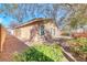 A backyard offering greenery, shrubbery, a partial view of the home's exterior and a gravel walkway at 6028 Stern Cove Ct, North Las Vegas, NV 89031