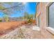 Backyard featuring block wall fencing and an exterior view of the home's side and windows at 6028 Stern Cove Ct, North Las Vegas, NV 89031