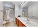 Well-lit bathroom featuring a shower-tub combo with white tiling and a spacious vanity at 6028 Stern Cove Ct, North Las Vegas, NV 89031