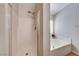 Bathroom view showcasing walk-in shower and a separate soaking tub next to a window at 6028 Stern Cove Ct, North Las Vegas, NV 89031