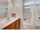 Clean bathroom with a shower-tub combination, white countertop, and wood-finish cabinetry at 6028 Stern Cove Ct, North Las Vegas, NV 89031