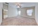 Spacious bedroom with neutral walls, carpet flooring, a ceiling fan, and natural lighting at 6028 Stern Cove Ct, North Las Vegas, NV 89031