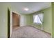 Bedroom featuring light green walls, carpet flooring, and natural lighting at 6028 Stern Cove Ct, North Las Vegas, NV 89031