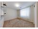 Bedroom featuring a white wall, carpet flooring, and natural light from a window at 6028 Stern Cove Ct, North Las Vegas, NV 89031