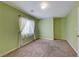 Bedroom with light green walls, carpet flooring, and natural light from a window at 6028 Stern Cove Ct, North Las Vegas, NV 89031