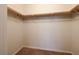 Bright walk-in closet with shelving, hanging rails, and neutral carpeting at 6028 Stern Cove Ct, North Las Vegas, NV 89031