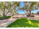 Community outdoor area featuring lush trees and plants with pavers, and a rock ground cover at 6028 Stern Cove Ct, North Las Vegas, NV 89031