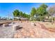 Relaxing community outdoor park featuring stone seating, mature trees, and a walkway at 6028 Stern Cove Ct, North Las Vegas, NV 89031