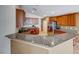 Modern kitchen featuring granite countertops, stainless steel appliances, and wood cabinets at 6028 Stern Cove Ct, North Las Vegas, NV 89031