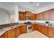 Bright kitchen with stainless steel appliances, granite counters and wood cabinets at 6028 Stern Cove Ct, North Las Vegas, NV 89031