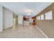 Bright living room with ample space, tile flooring and open layout to kitchen at 6028 Stern Cove Ct, North Las Vegas, NV 89031