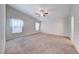 Spacious main bedroom with plush carpeting, vaulted ceiling and two windows at 6028 Stern Cove Ct, North Las Vegas, NV 89031