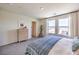 Well-lit bedroom features two large windows and a wooden dresser at 6164 Aster Garden St # 137, North Las Vegas, NV 89081