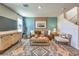 Cozy living room showcasing stylish decor, a brown sofa, and decorative rug at 6164 Aster Garden St # 137, North Las Vegas, NV 89081