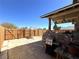 Private backyard featuring a patio area, wooden fence, and stone accents at 628 Avenue L, Boulder City, NV 89005