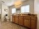 Bathroom featuring a tile floor, wood cabinets, and a large mirror at 628 Avenue L, Boulder City, NV 89005